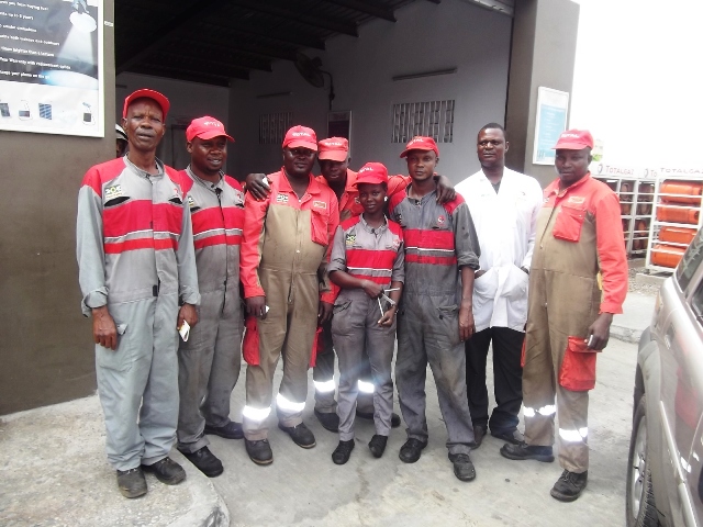 Mary(middle) and his male professional colleagues attached to Lagos Sheraton Total Station Automatic Fit Auto Service Centre